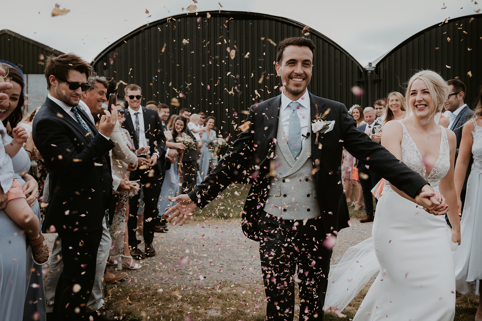 Confetti being thrown over the bride and groom at Norton Fields